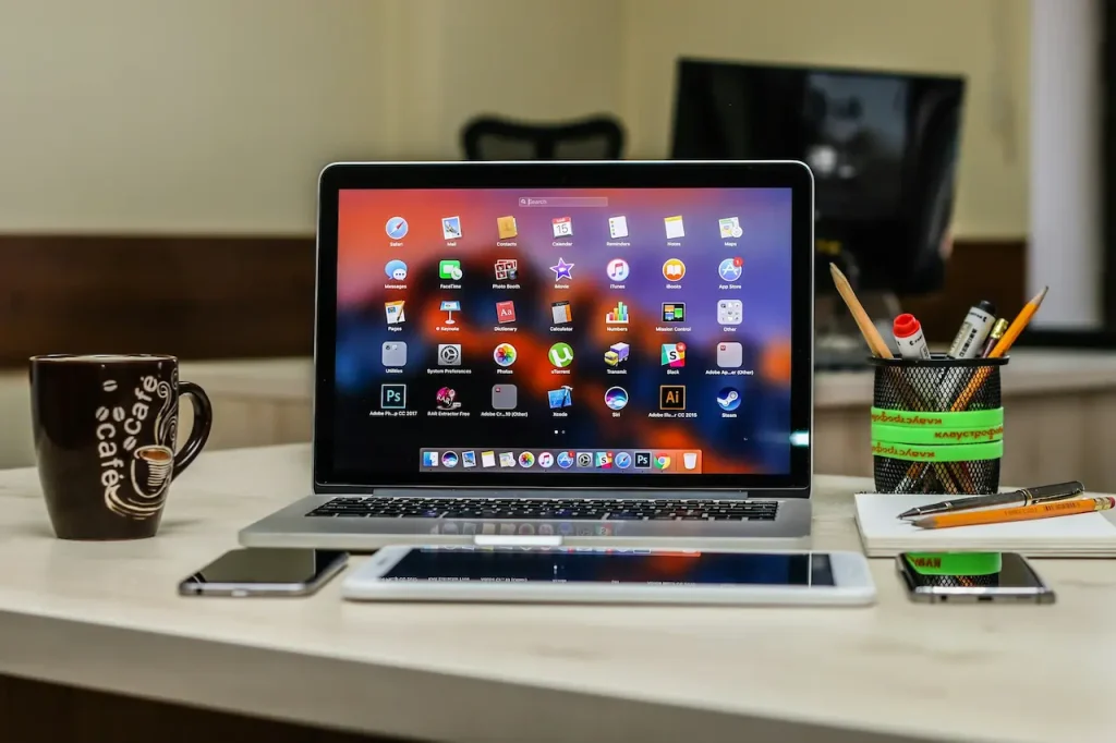 Laptop Next to a Cellphone and Tablet