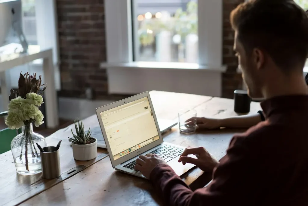 Man Using the Laptop in the Table 