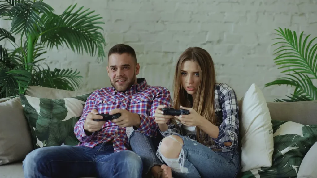 A Couple Playing Video Games on the Sofa 