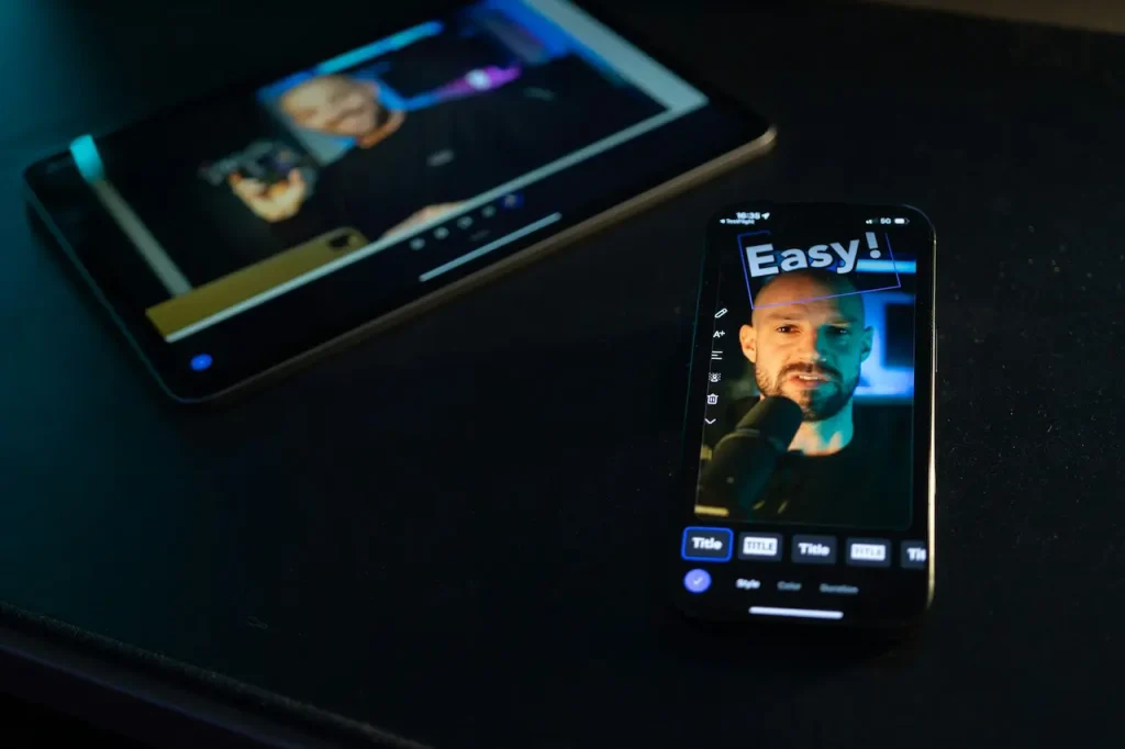 A Man Recording Video on His iPhone and iPad 