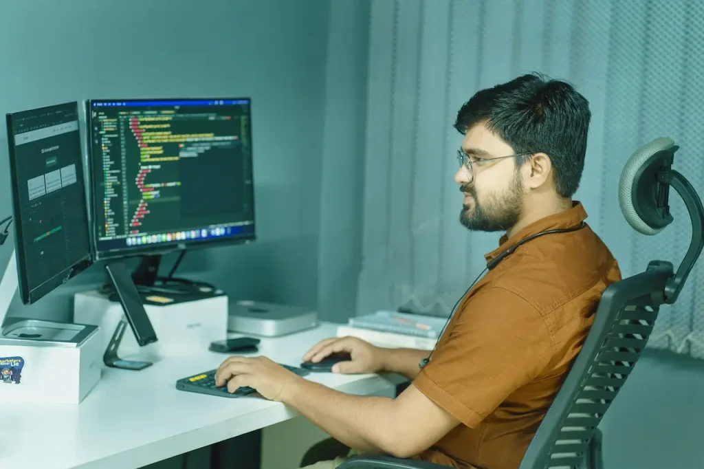 A Man Writing Some Code on His Computer 