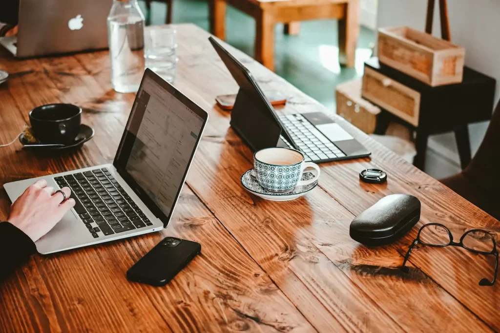 A Woman Working on Her MacBook Pro while Having a Coffee