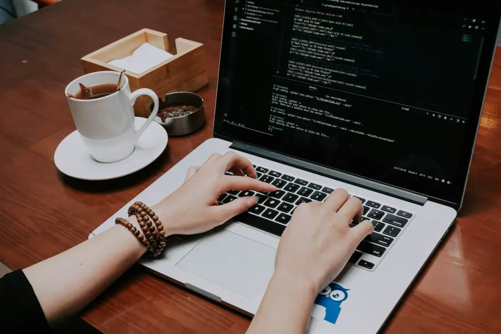 Person Writing Some Code on His MacBook 