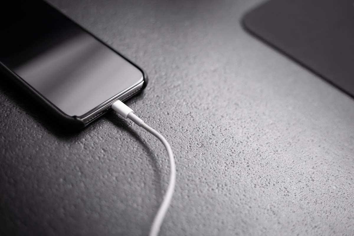 A smartphone connected to a charging cable