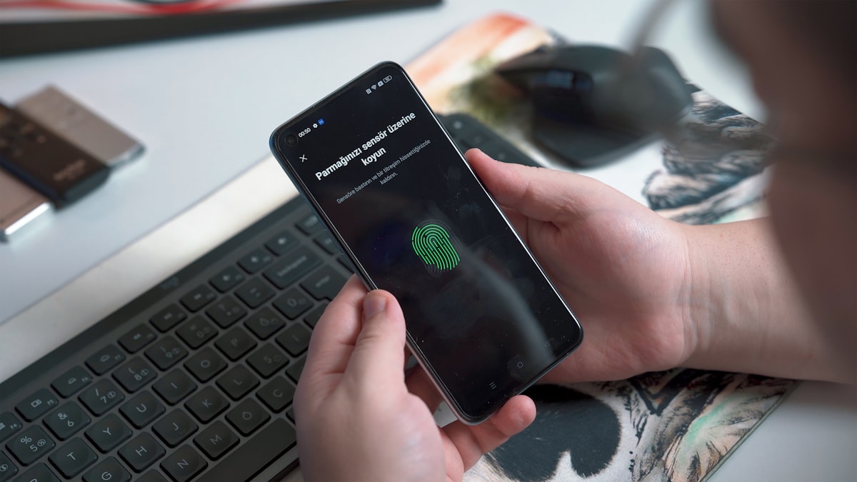 Person using fingerprint authentication to secure their smartphone