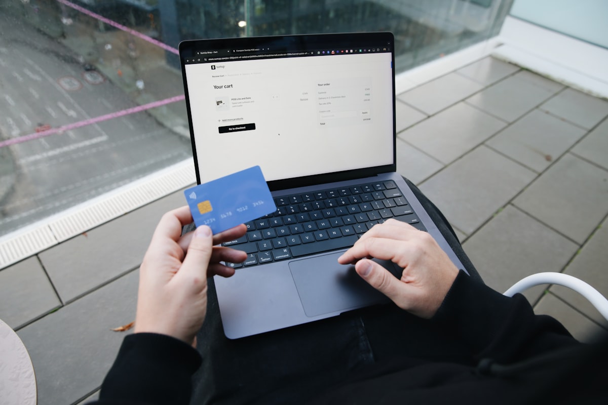 A person entering credit card details on a laptop