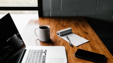 Laptop, coffee mug and smartphone on an office desk