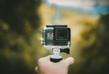 Person holding an action camera outdoors