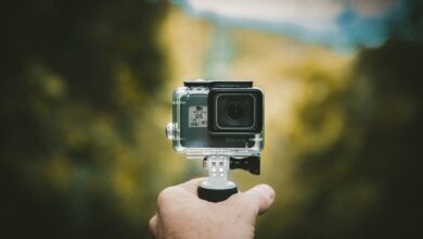 Person holding an action camera outdoors