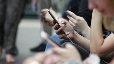 Teenager holding a smartphone showing a social media app