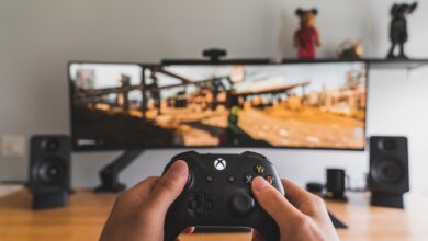 Person holding a game controller for cloud gaming