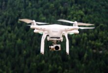 Camera drone flying against the sky