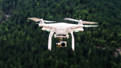 Camera drone flying against the sky