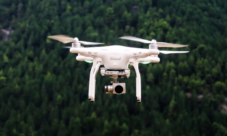 Camera drone flying against the sky