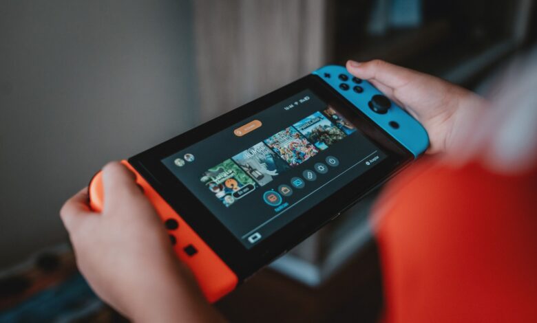 Handheld gaming console being held outdoors