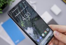Person holding a smartphone, representing the Google Pixel 10