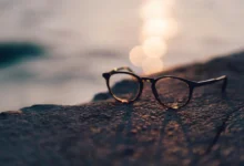 A pair of glasses resting on a rock at sunset, representing AI smart glasses