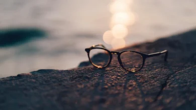 A pair of glasses resting on a rock at sunset, representing AI smart glasses