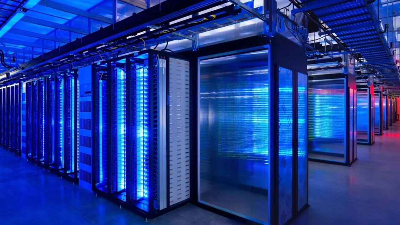 Rows of illuminated blue server racks in a data centre, the kind of infrastructure that runs AI browser assistants