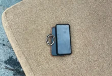 Two Android smartphones stacked together on an outdoor chair cushion