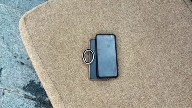 Two Android smartphones stacked together on an outdoor chair cushion