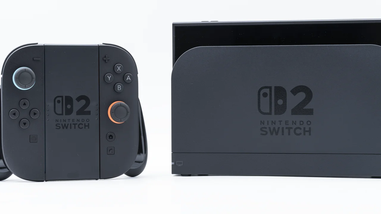 Nintendo Switch 2 console and Joy-Con controllers beside the official dock, both showing the Switch 2 logo