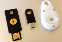Three physical FIDO2 security keys, used to create passkeys without a phone, lined up on a table