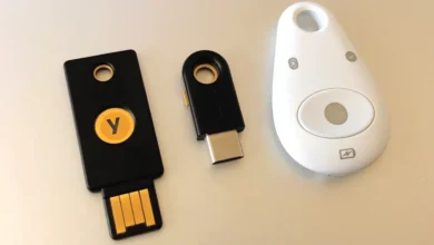 Three physical FIDO2 security keys, used to create passkeys without a phone, lined up on a table