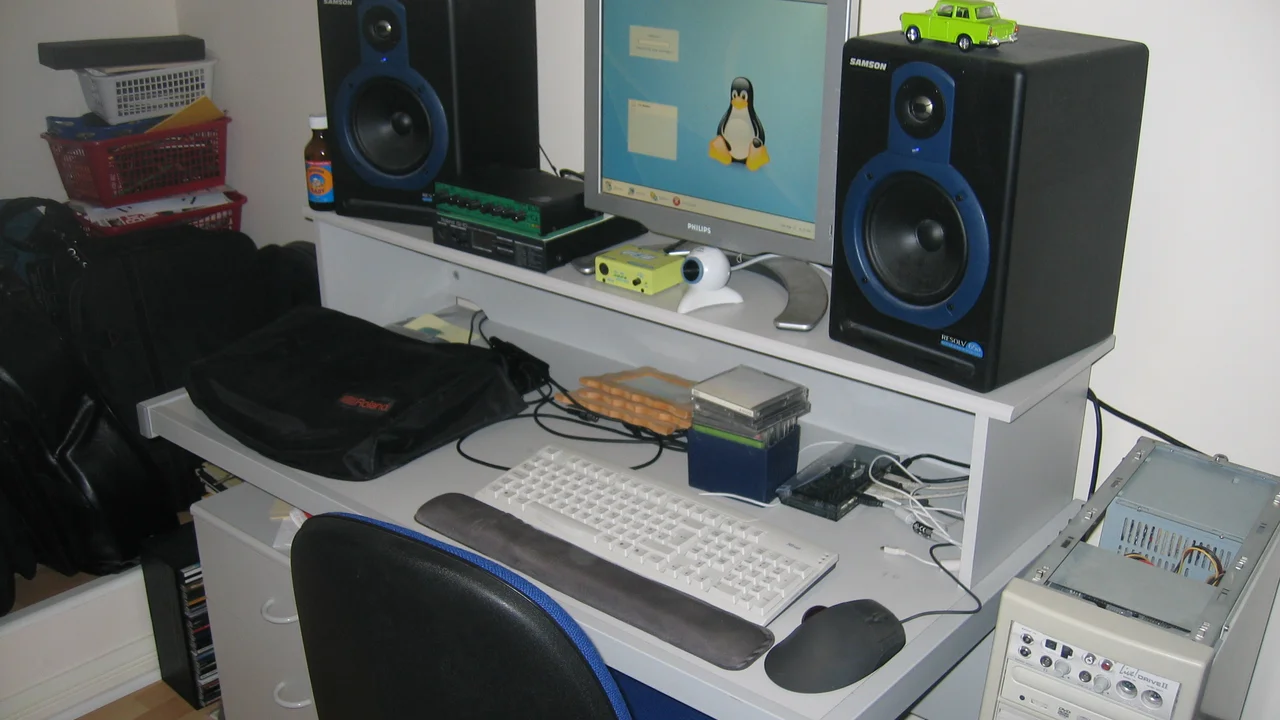 Solid-state drive and RAM modules laid next to an open desktop PC case