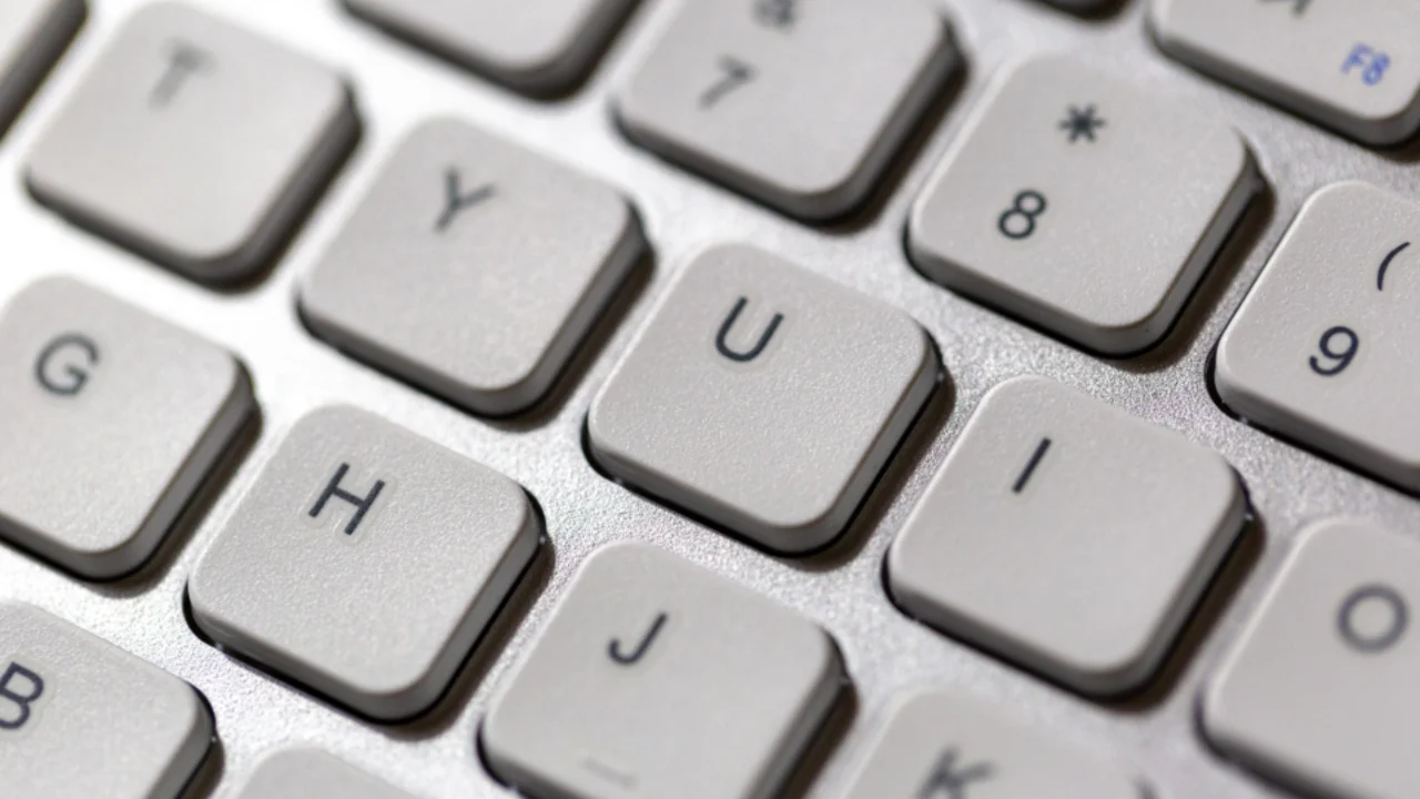 Close-up of white computer keyboard keys showing letters and numbers